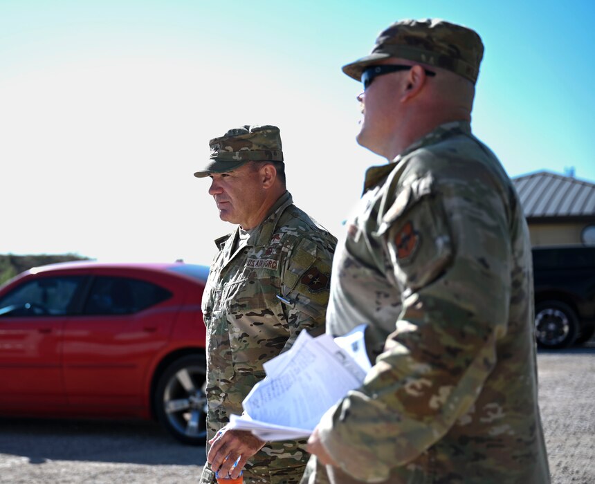U.S. Air Force Maj. Gen. Wolfe Davidson, Second Air Force Commander, walks with Lt. Col. Garrett Williams, 313th Training Squadron Commander, at the Joint All-Domain Expeditionary Forward Operations Readiness Generation Exercise site, Goodfellow Air Force Base, Texas, Oct. 1, 2024. JADE FORGE immerses joint service intelligence professionals in a simulated operational environment, enabling them to apply essential intelligence functions—analysis, collection, integration, and targeting—in a realistic setting. (U.S. Air Force photo by Airman 1st Class Madi Collier)