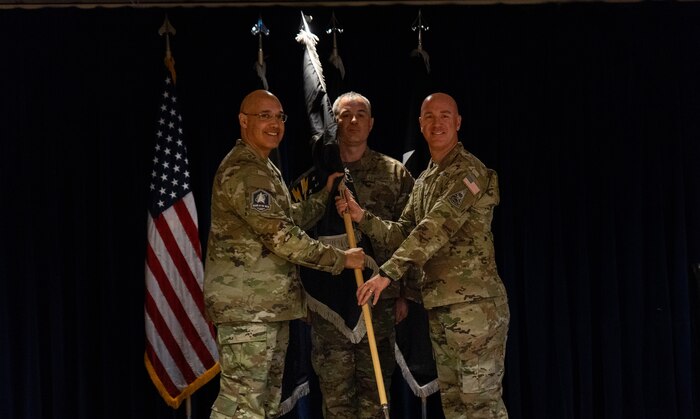U.S. Space Force Lt. Gen. David N. Miller, Jr., Space Operations Command commander, Colonel Andrew Menschner, Mission Delta 31 commander, and Chief Master Sgt. Joshua Griffin, MD 31 senior enlisted leader, pass the ceremonial guidon during a redesignation ceremony at Peterson Space Force Base, Colo., Oct. 15, 2024. During the ceremony the Position, Navigation and Timing (PNT) Provisional Delta was officially redesignated as Mission Delta 31. The Delta continues to provide, operate and sustain high-integrity PNT capabilities to protect our nation’s interests and assure an unparalleled global utility of the Global Positioning Satellite constellation, but with additional units dedicated to future capability development. (U.S. Space Force photo by John Ayre)