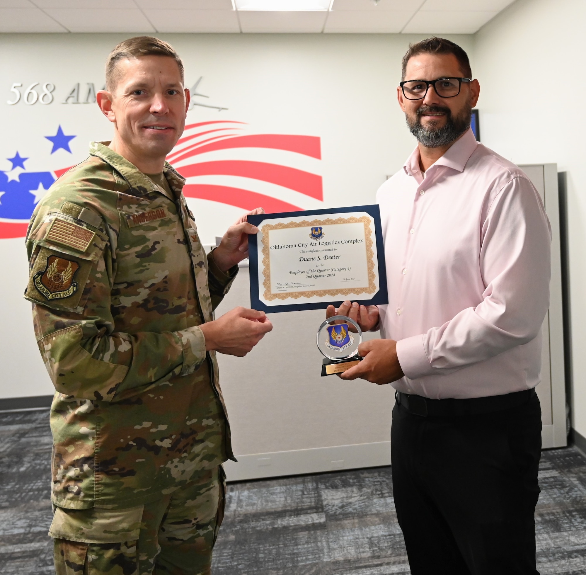 Two men holding a certificate