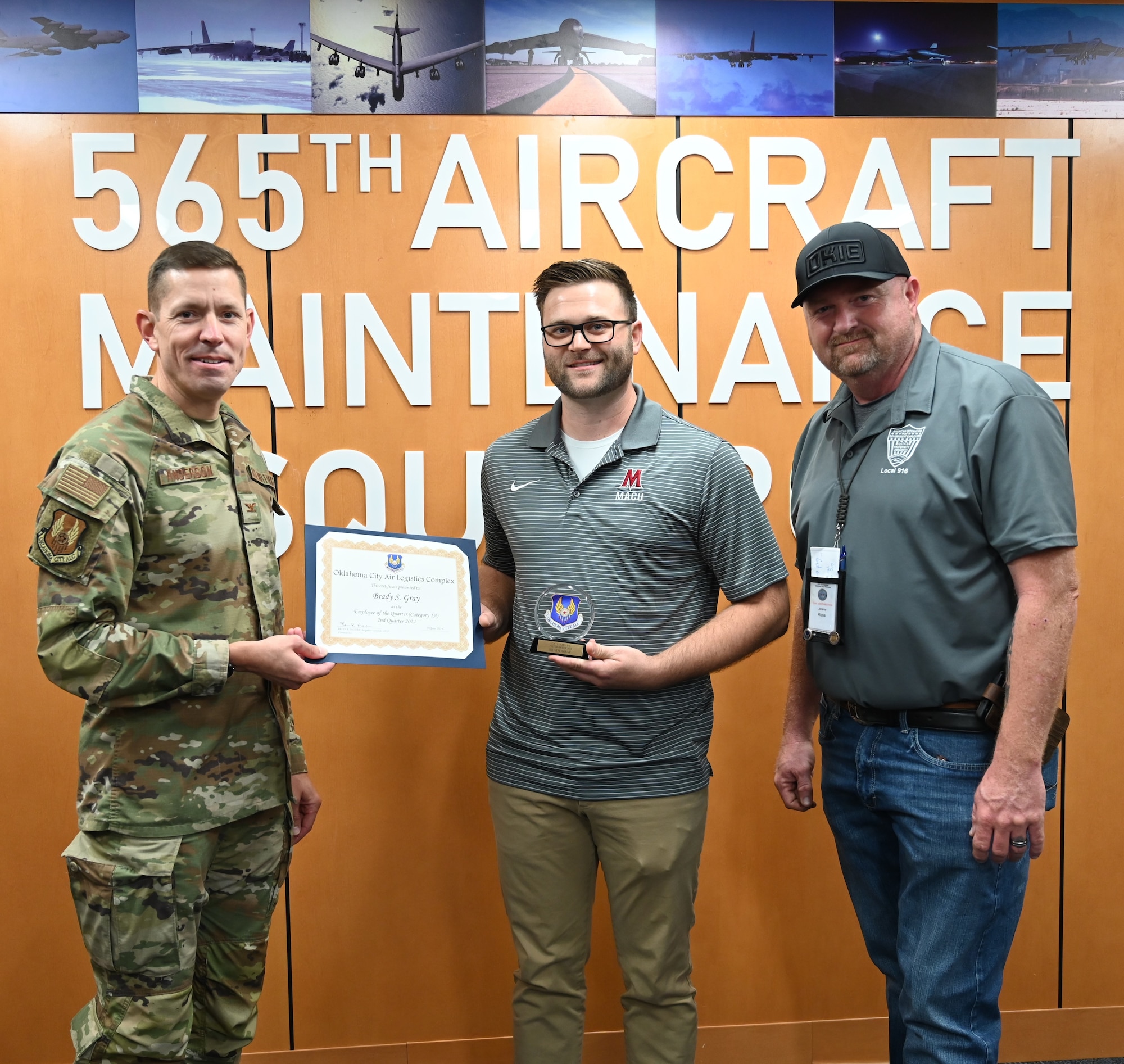 Three men holding a certificate