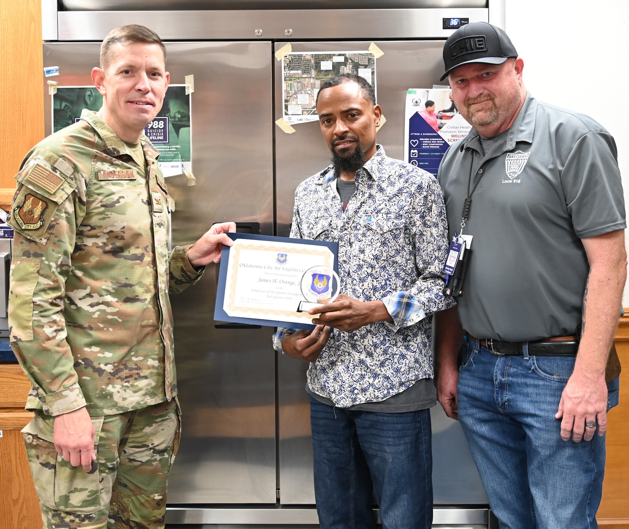 Three men holding a certificate