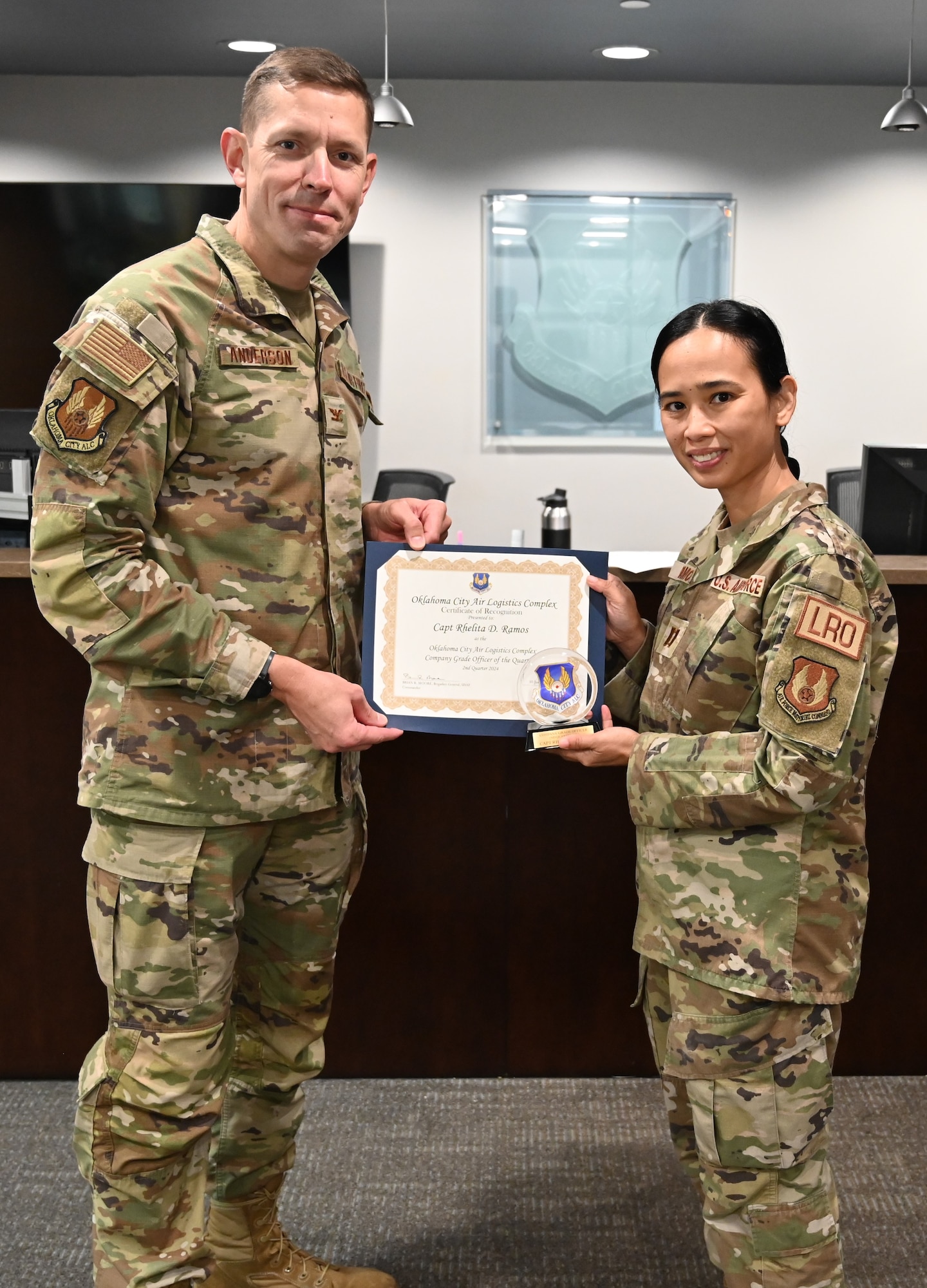 Man and woman holding a certificate