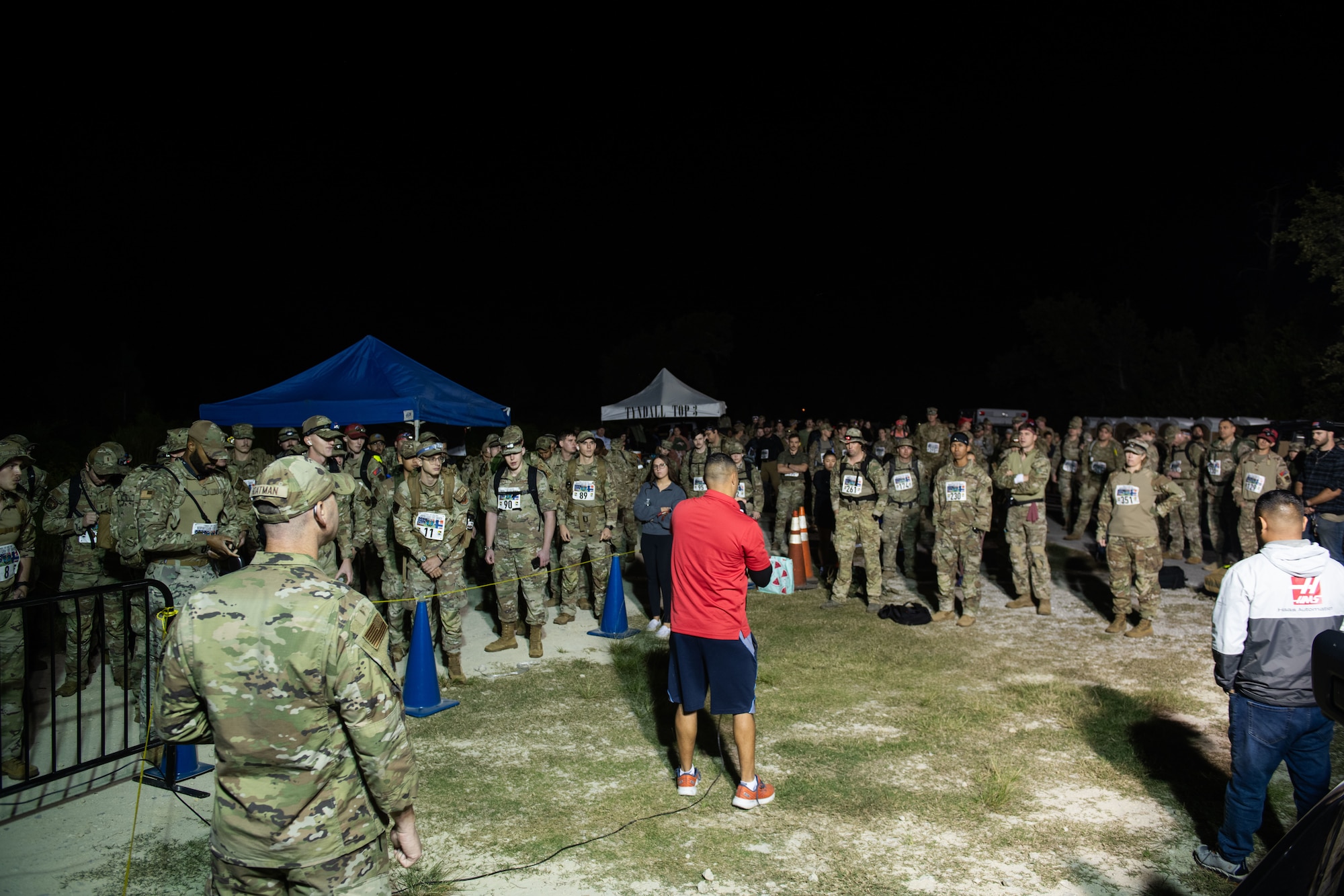 Retired U.S. Air Force Chief Master Sgt. Luis Reyes gives a speech before a ruck march.