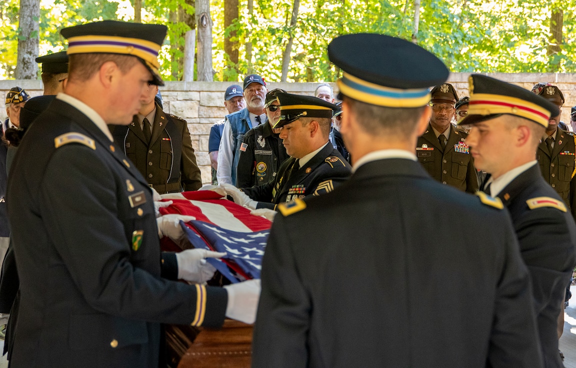 A Military Funeral and Honors team folds the funeral flag which draped the casket of Illinois Army National Guard Pfc. Harry Jerele at the Abraham Lincoln National Cemetery in Elwood Oct. 4.