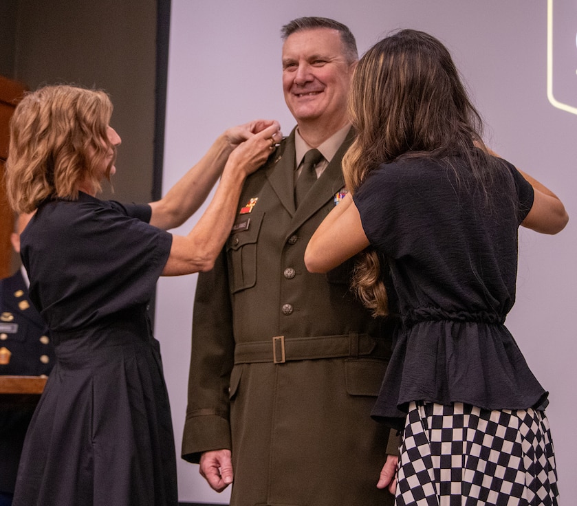 Liane Kelly, left, and Morgan Kelly, wife and daughter of newly-promoted Brig. Gen. Lenny Williams, Assistant Adjutant General – Army and Commander of the Illinois Army National Guard, pin brigadier general stars on his uniform during a promotion ceremony Oct. 11 at the Illinois Military Academy, Camp Lincoln, Springfield.