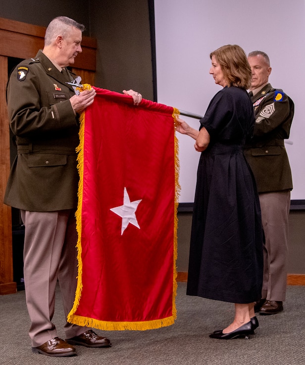 Newly-promoted Brig. Gen. Lenny Williams, Assistant Adjutant General – Army and Commander of the Illinois Army National Guard, and wife, Liane Kelly, unfurl Williams’ general officer flag during a promotion ceremony Oct. 11 at the Illinois Military Academy, Camp Lincoln, Springfield.