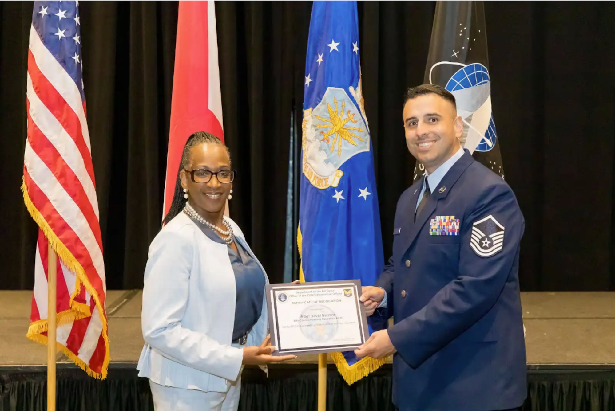 U.S. Air Force Master Sgt. David Herrera, 47th Communication Squadron (CS) network control center section chief, accepts his award from Venice Goodwine, Department of the Air Force Chief Information Officer at Montgomery, Ala. Aug. 2024. Herrera won the 2024 Department of the Air Force Chief Information Officer Outstanding Enlisted Professional of the Year. (Courtesy photo)