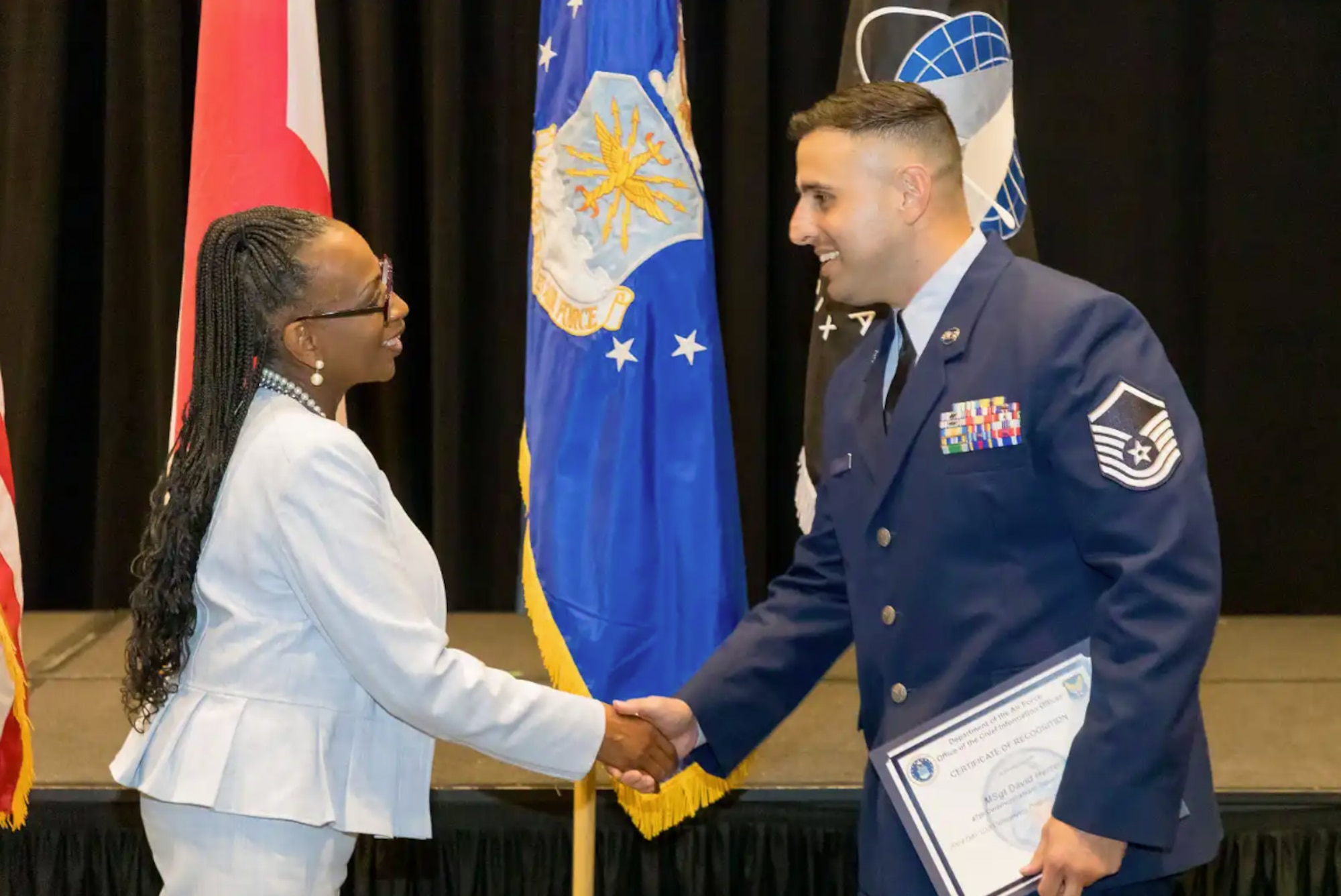 U.S. Air Force Master Sgt. David Herrera, 47th Communication Squadron (CS) network control center section chief, accepts his award from Venice Goodwine, Department of the Air Force Chief Information Officer at Montgomery, Ala. Aug. 2024. Herrera won the 2024 Department of the Air Force Chief Information Officer Outstanding Enlisted Professional of the Year. (Courtesy photo)