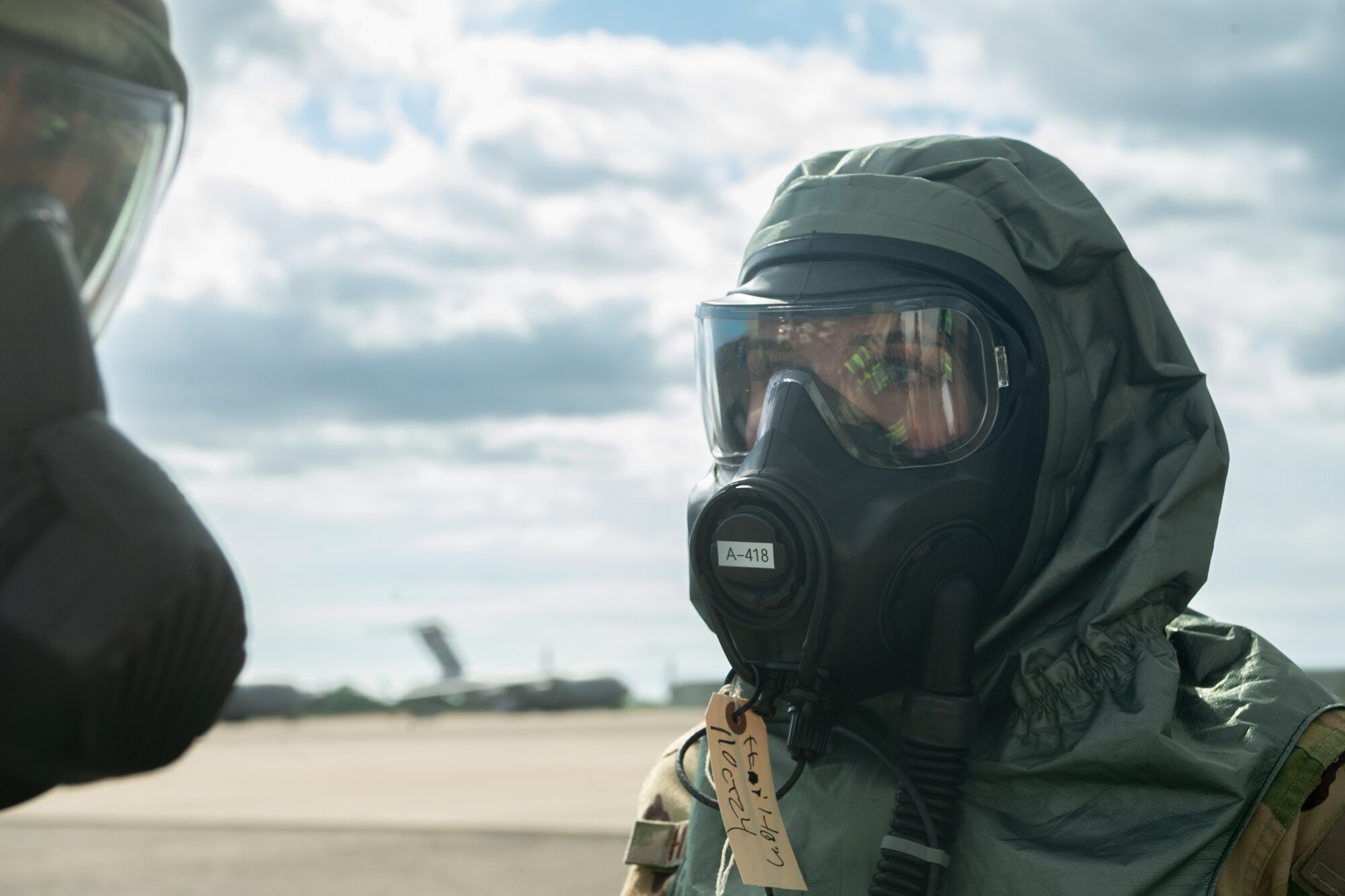 U.S. Air Force Staff Sgt. Tayshawn Burl, 7th Expeditionary Airlift Squadron aircrew flight equipment technician, simulates scanning Senior Airman Katheryn Hamilton, 7th EAS loadmaster, for radiological contamination during Exercise Rainier War 25A, at Kalaeloa, Hawaii, Oct. 11, 2024.
