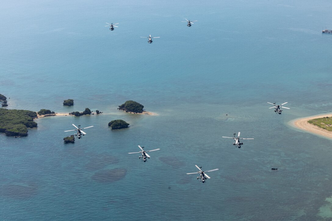 U.S. Marine Corps UH-1Y Venom and AH-1Z Viper helicopters with Marine Light Attack Helicopter Squadron 367, deployed to 1st Marine Aircraft Wing, III Marine Expeditionary Force, fly in formation off the coast of Okinawa, Japan, Oct. 11, 2024.