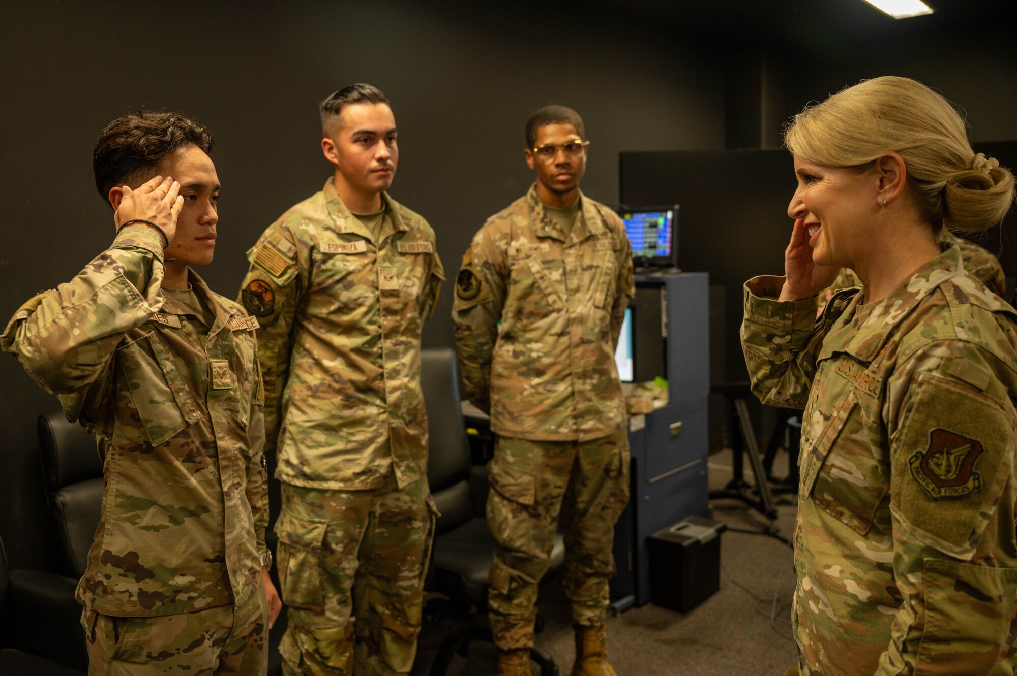 A service member salutes a higher ranking service member who is saluting back.