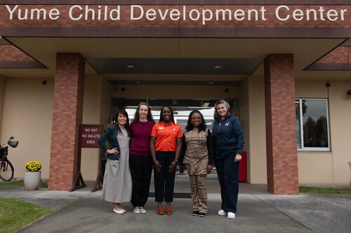 Gina Allvin, right, spouse of U.S. Air Force Chief of Staff Gen. David Allvin, and other key support liaisons pose for a photo with Yokota Youth Center employees at Yokota Air Base
