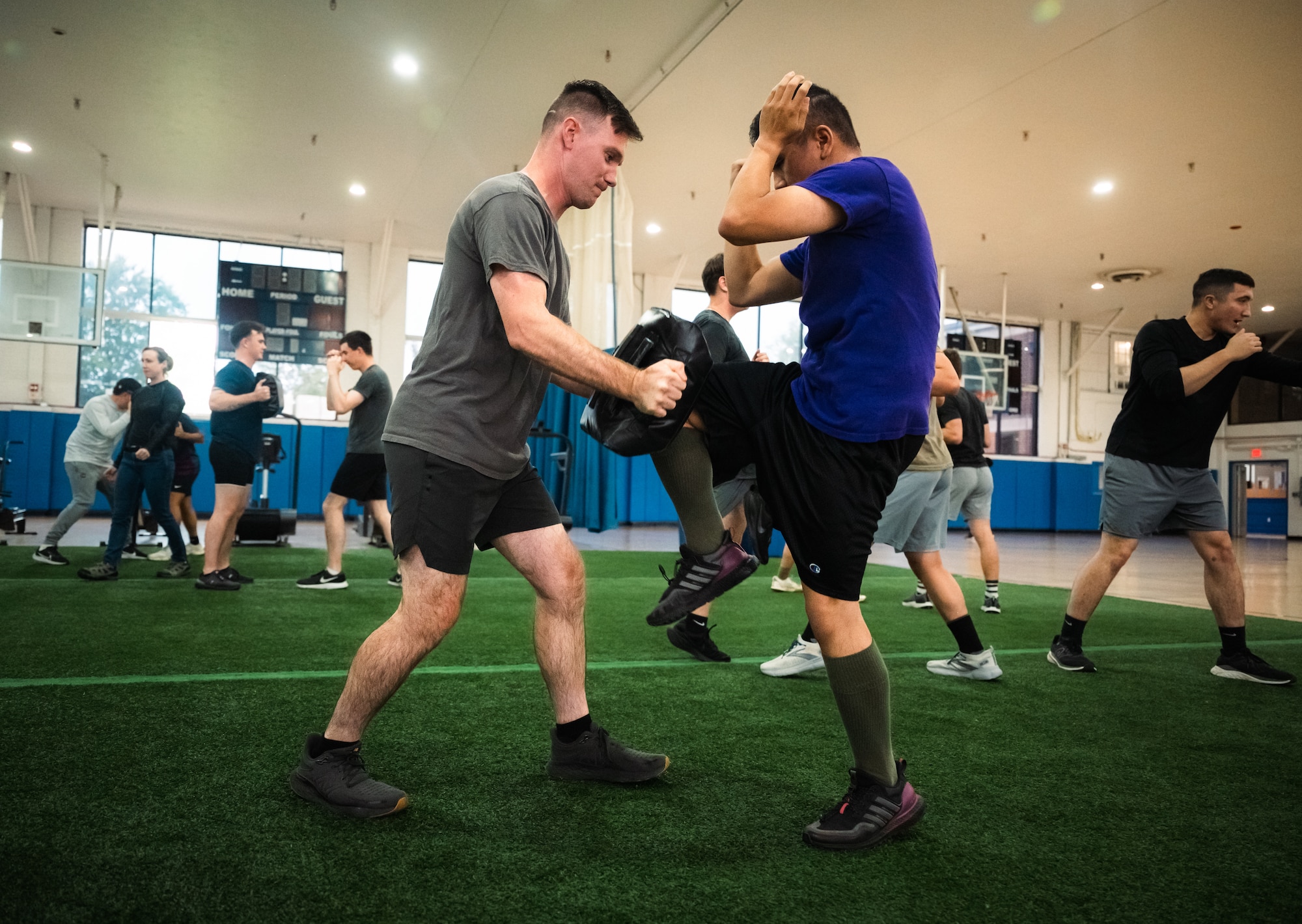 Airman knees Airman holding a block