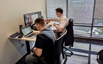 military members in civilian clothes work on computers