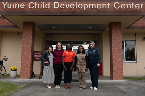 Gina Allvin, right, spouse of U.S. Air Force Chief of Staff Gen. David Allvin, and other key support liaisons pose for a photo with Yokota Youth Center employees at Yokota Air Base