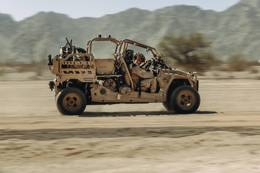 U.S. Marine Corps Pfc. Julian Johnson, left, a Philadelphia, Pennsylvania native, and Lance Cpl. Daylon Godsey, a San Bernardino, California native, low altitude air defense gunners assigned to 3rd Low Altitude Air Defense Battalion, 3rd Marine Aircraft Wing operate a Light Marine Air Defense Integrated System during a ground-based air defense exercise as part of Weapons and Tactics Instructor course 1-25 at Tacts Airfield near Wellton, Arizona, Oct. 10, 2024. WTI is a seven-week training event hosted by Marine Aviation Weapons and Tactics Squadron One which emphasizes operational integration of the six functions of Marine aviation in support of the Marine Air Ground Task Force, Joint and Coalition Forces. (U.S. Marine Corps photo by Lance Cpl. Micah Thompson)