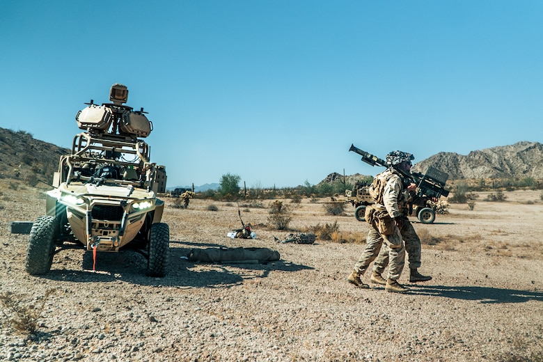 U.S. Marine Corps Pfc. Julian Johnson, left, a Philadelphia, Pennsylvania native and Lance Cpl. Brayden Westcott, a Midland, Texas native, both low altitude air defense gunners assigned to 3rd Low Altitude Air Defense Battalion, 3rd Marine Aircraft Wing, participate in a ground-based air defense exercise as part of Weapons and Tactics Instructor course 1-25 at Tacts Airfield, near Wellton, Arizona, Oct. 10, 2024. WTI is a seven-week training event hosted by Marine Aviation Weapons and Tactics Squadron One which emphasizes operational integration of the six functions of Marine aviation in support of the Marine Air Ground Task Force, Joint and Coalition Forces. (U.S. Marine Corps photo by Cpl. Maurion Moore)