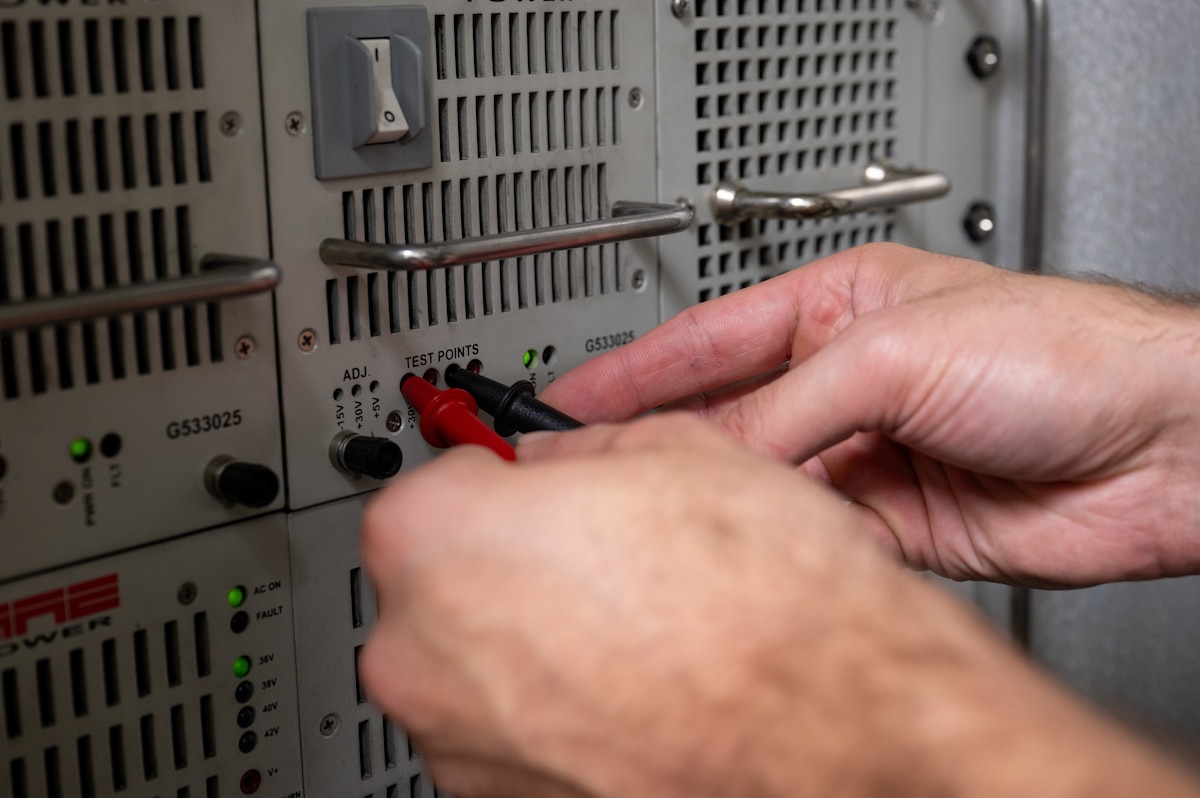 U.S. Air Force Senior Airman James Dittmann, 39th Operations Support Squadron Radar, Airfield and Weather Systems supervisor, uses a voltmeter to check the voltage of a digital airport surveillance radar (DASR) power supply, Oct. 10, 2024, at Incirlik Air Base, Türkiye