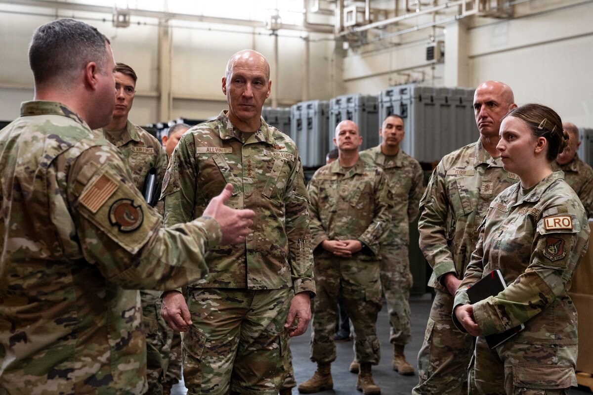 Military members brief a high ranking military member.