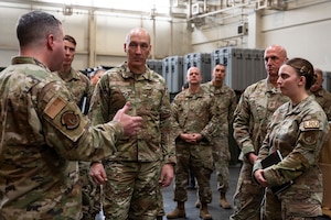 Military members brief a high ranking military member.