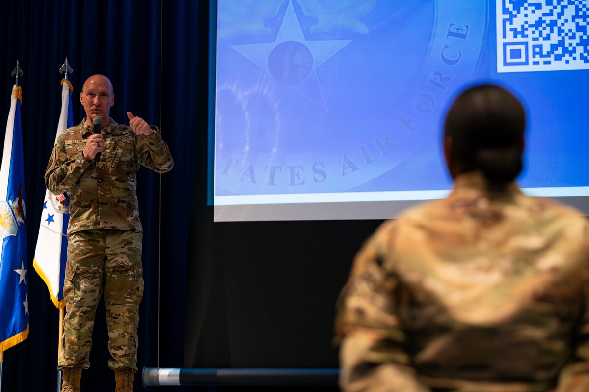 A military member stands on a stage.