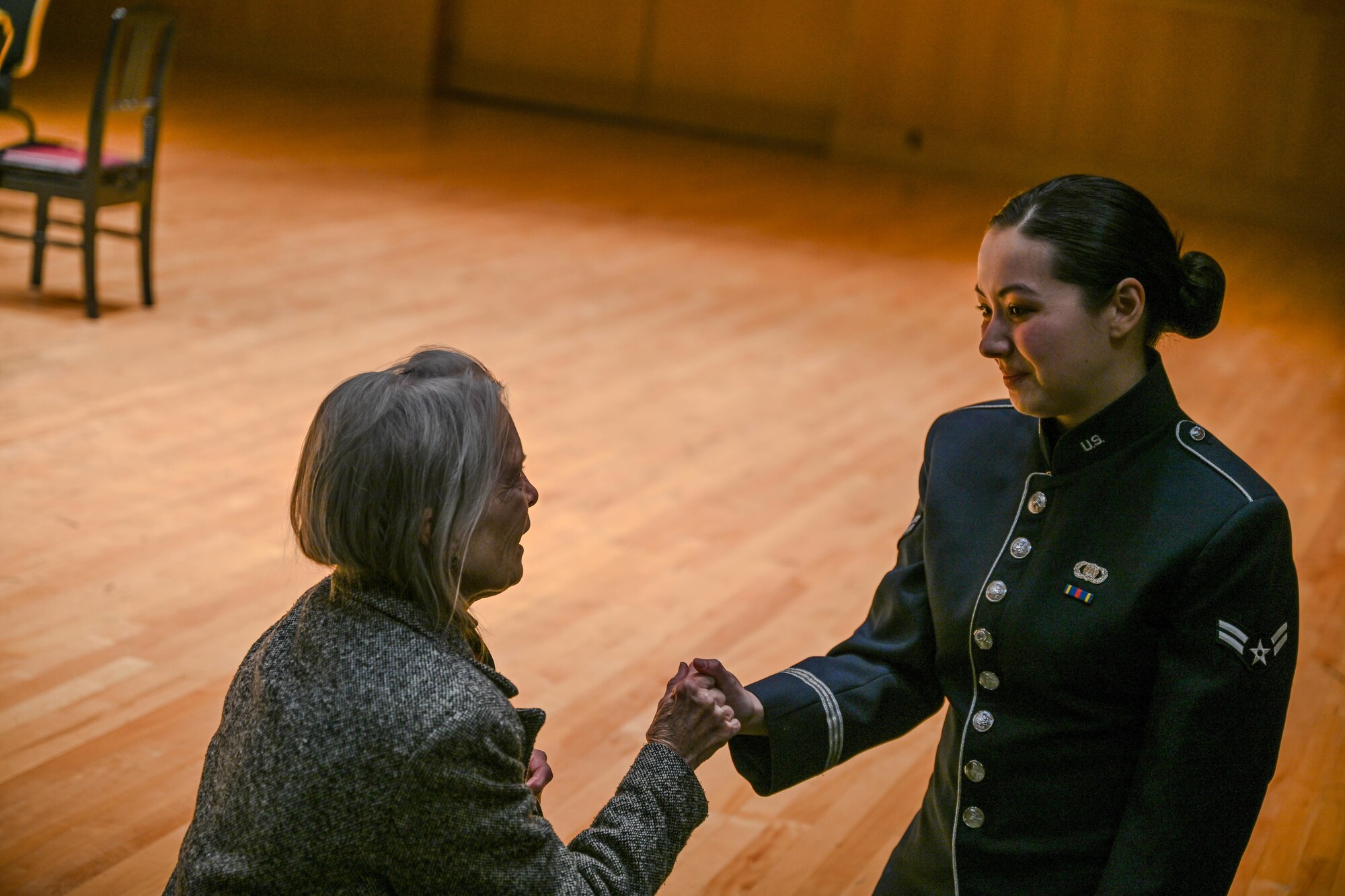 Airman 1st Class Yuna Langehenning, Heritage of America Band, Heritage Winds musician, shakes a community member's hand after a public concert at the Ford Recital Hall, DeYor Performing Arts Center, Youngstown, Ohio, Oct. 15, 2024.