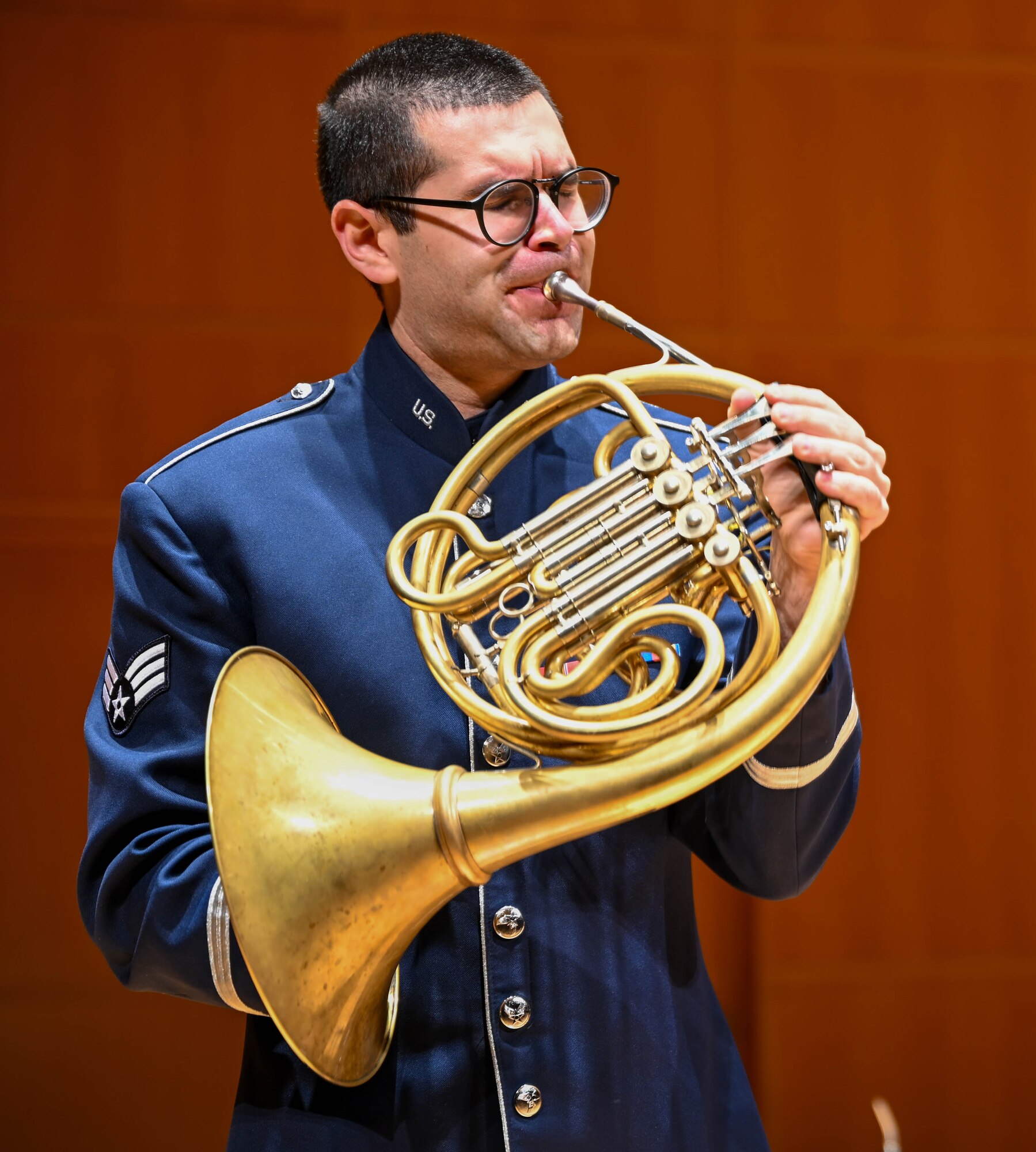 Senior Airman Cooper Johnson, U.S. Air Force Heritage of America Band, Heritage Winds musician, plays the french horn during a public concert at the Ford Recital Hall, DeYor Performing Arts Center, Youngstown, Ohio, Oct. 15, 2024.