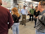 A group of people are looking at display cases in a museum.