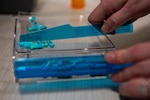 A U.S. Airman assigned to 60th Diagnostics and Therapeutics Squadron sorts through medicine for a patient’s prescription at the base pharmacy at Travis Air Force Base, California, Jan. 26, 2024. The pharmacy fills approximately 520,000 prescriptions per year to service members, their families and veterans. The Defense Logistics Agency Troop Support Medical supply chain and the Department of Veterans Affairs work together to negotiate better value on prescription drugs. This work includes procurement of pharmaceuticals for veterans, DOD beneficiaries and patients of other federal healthcare systems. Photo by Kenneth Abbate.