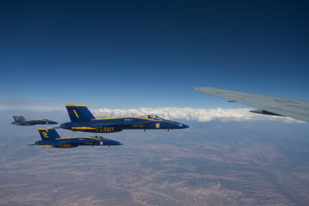 Three U.S. Navy Blue Angels F/A-18 Super Hornet aircraft fly next to a KC-46 Pegasus aircraft in the skies of Texoma, Oct. 14, 2024. Aerial refueling allowed the Blue Angels to fly for extended periods without having to land for refueling. (U.S. Air Force photo by Airman 1st Class Lauren Torres)