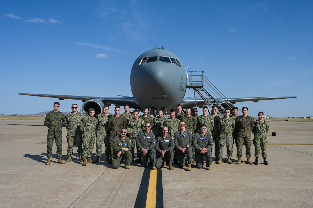 U.S. Air Force Airmen and The University of Oklahoma Naval ROTC pose for a photo in front of a KC-46 Pegasus aircraft at Altus Air Force Base, Oklahoma, Oct. 14, 2024. The midshipmen had the opportunity to experience aerial refueling of the U.S. Navy Blue Angels by the 56th Aerial Refueling Squadron. (U.S. Air Force photo by Airman 1st Class Lauren Torres)