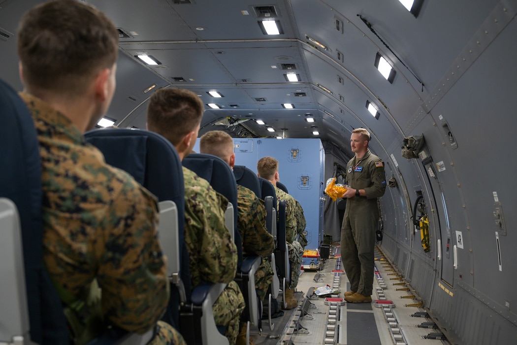 U.S. Air Force Staff Sgt. Tanner Todd, 56th Air Refueling Squadron instructor boom operator, briefs The University of Oklahoma Naval ROTC midshipmen in a KC-46 Pegasus aircraft at Altus Air Force Base, Oklahoma, Oct. 14, 2024. Todd explained the importance of in-flight safety and how to respond to emergencies. (U.S. Air Force photo by Airman 1st Class Lauren Torres)