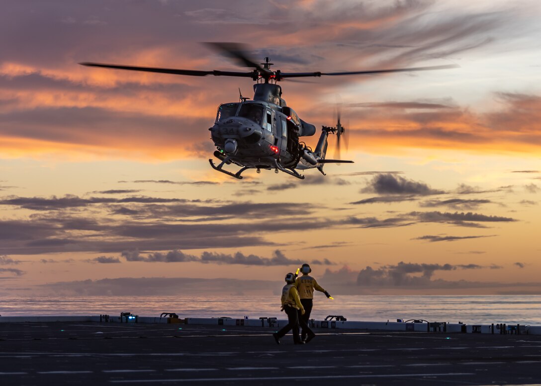 PHILIPPINE SEA (Sept. 28, 2024) A U.S. Marine Corps UH-1Y Venom attached to Marine Medium Tiltrotor Squadron (VMM) 165 (Reinforced), 15th Marine Expeditionary Unit, prepares to land aboard the expeditionary sea base USS Miguel Keith (ESB 5) in the Philippine Sea, Sept. 28, 2024. Elements of the 15th MEU are embarked aboard Miguel Keith conducting routine operations in the U.S. 7th Fleet area of operations. ESB-class ships, like Miguel Keith, enable sea-based expeditionary forces, such as the 15th MEU, to maintain forward presence with the capability to quickly deploy forces, supplies and warfighting capabilities. 7th Fleet is the U.S. Navy’s largest forward-deployed numbered fleet, and routinely interacts and operates with allies and partners in preserving a free and open Indo-Pacific. (U.S. Marine Corps photo by Capt. Staci Morris)