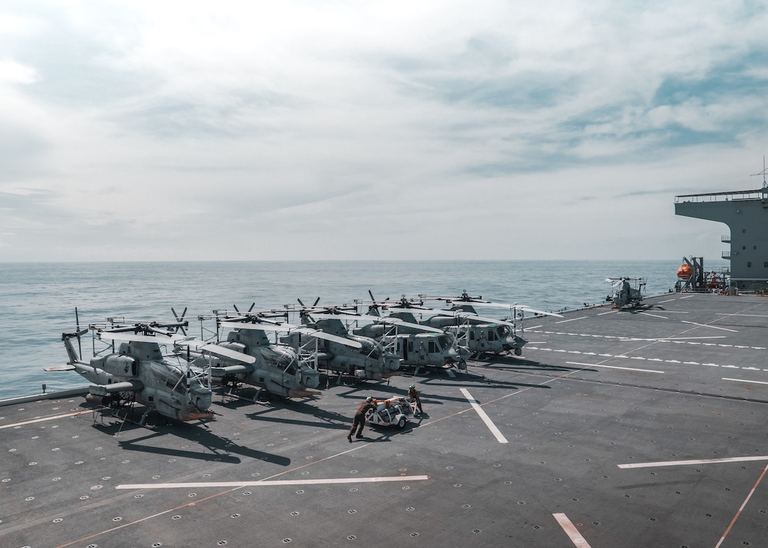 PHILIPPINE SEA (Sept. 26, 2024) U.S. Marine Corps AH-1Z Vipers and UH-1Y Venoms attached to Marine Medium Tiltrotor Squadron (VMM) 165 (Reinforced), 15th Marine Expeditionary Unit, rest on the flight deck of the expeditionary sea base Miguel Keith (ESB 5) while underway in the Philippine Sea, Sept. 26, 2024. Elements of the 15th MEU are embarked aboard Miguel Keith conducting routine operations in the U.S. 7th Fleet area of operations. ESB-class ships, like Miguel Keith, enable sea-based expeditionary forces, such as the 15th MEU, to maintain forward presence with the capability to quickly deploy forces, supplies and warfighting capabilities. 7th Fleet is the U.S. Navy’s largest forward-deployed numbered fleet, and routinely interacts and operates with allies and partners in preserving a free and open Indo-Pacific. (U.S. Marine Corps photo by Capt. Staci Morris)