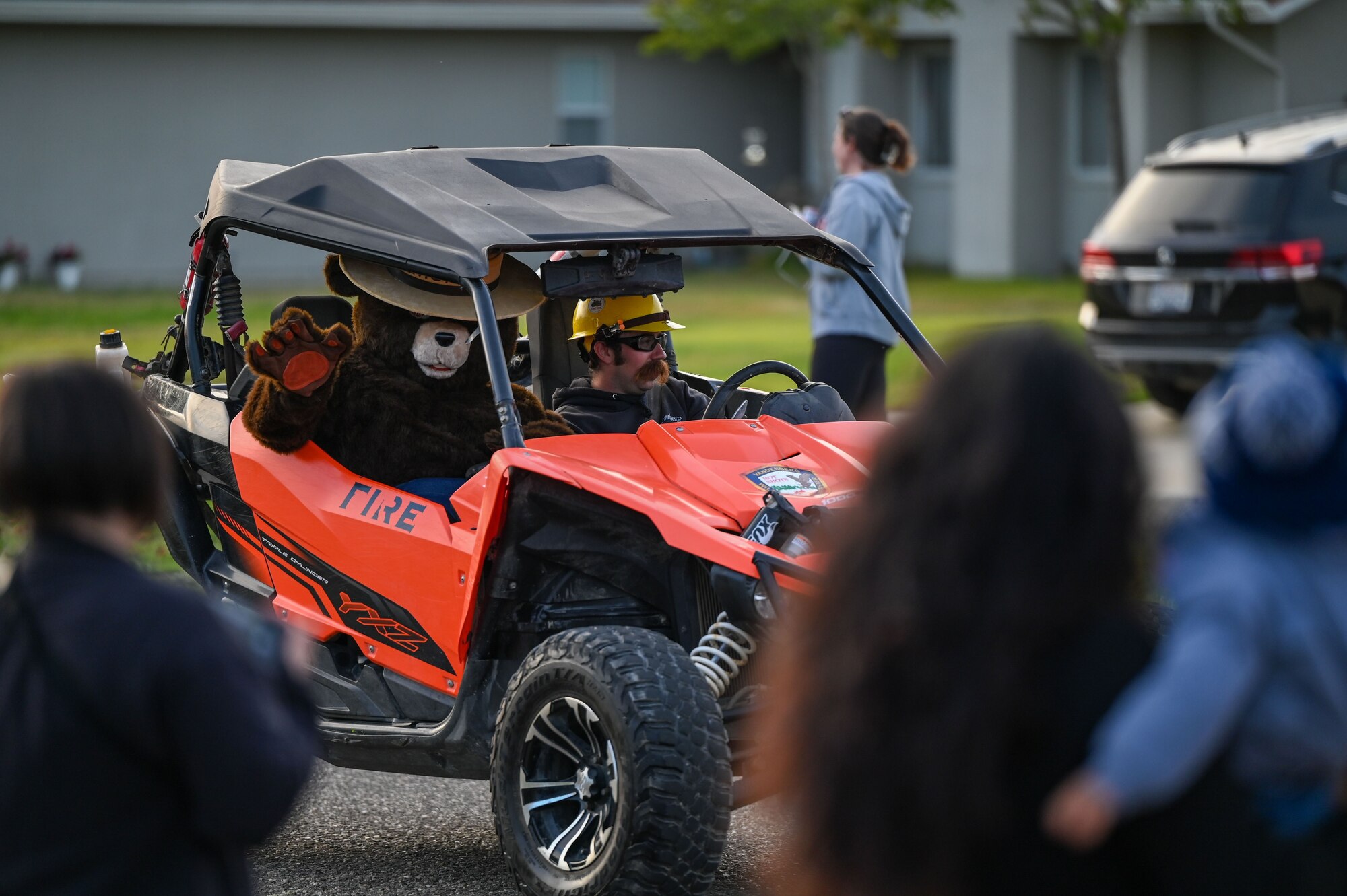 An off-roading vehicle drives down a street.