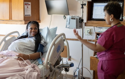 Mother-to-be Janae Lettley, wife of Navy Constructionman Taurian Jones, gets ready for an induced birth with the help of Nurse Yohade Jaleta, RN MSN, in her birthing room at Walter Reed’s Mother-Infant Care Center in Bethesda, Maryland, October 9, 2024.