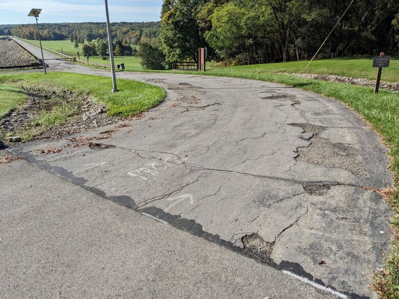 A paved road near a reservoir.
