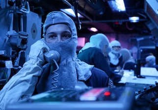 OS2 Nathan Rosekrans stands watch in the combat information center during a general quarters drill aboard USS Dewey (DDG 105) in the Andaman Sea.