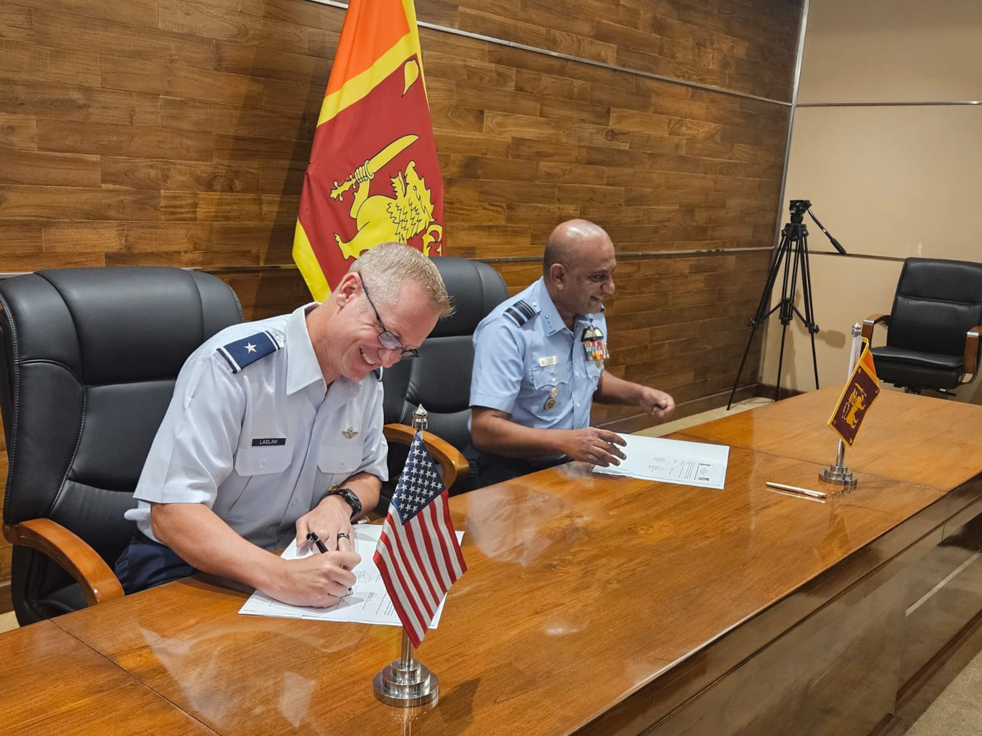 U.S. Air Force Brig. Gen. Brian S. Laidlaw, Pacific Air Forces Director of Strategy, Plans, Programs, and Requirements, signs the Minutes of the Meeting with Sri Lanka Air Force’s Director General of Planning Air Vice Marshal Bandu Edirisinghe, during the 7th Annual Airman-to-Airman Talks, at the Sri Lanka Defense Headquarters in Colombo, from Sept. 10-12, 2024. (Courtesy photo)