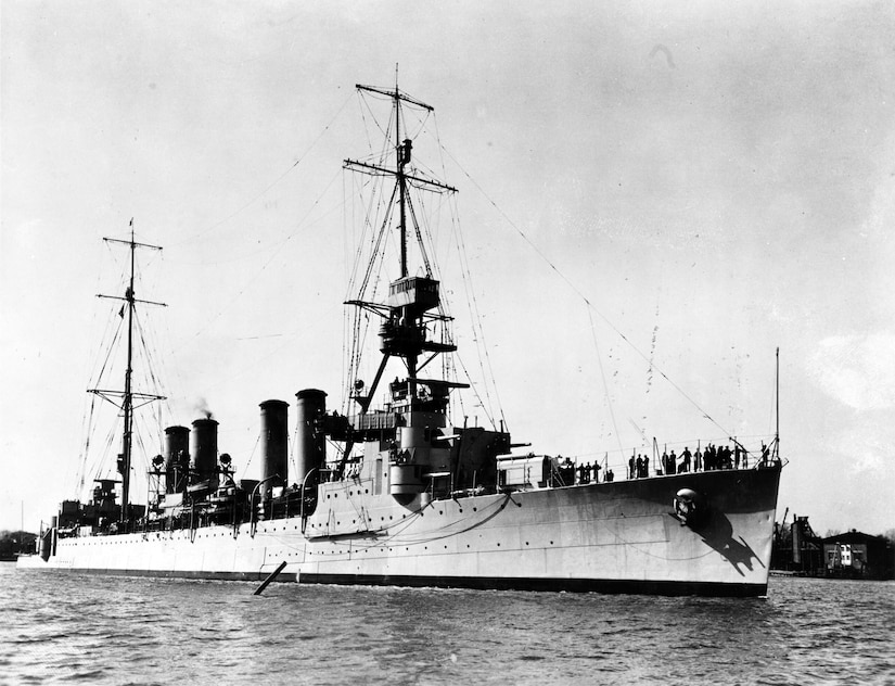 A two-mast ship sits in water.
