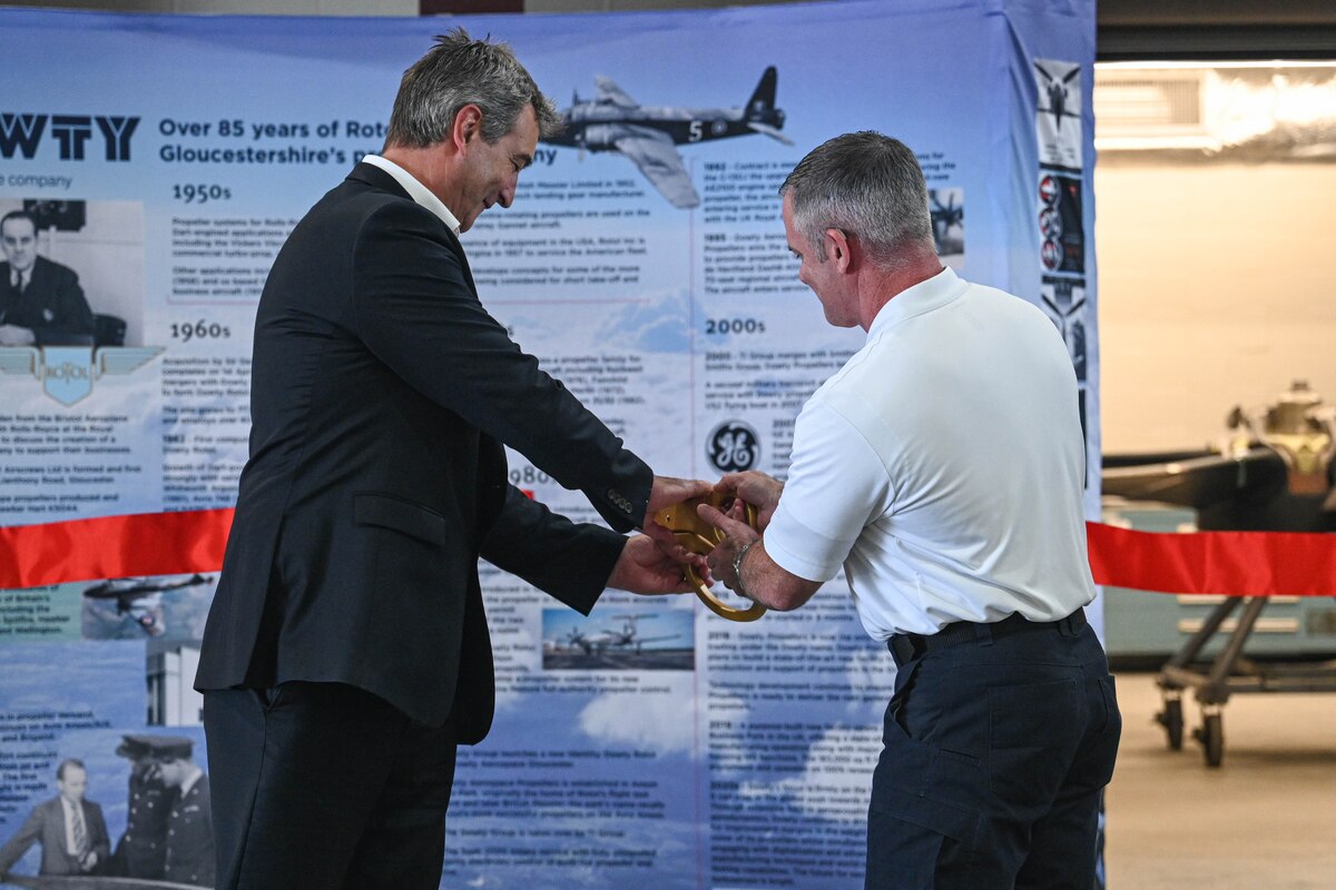 Kerry Garfield, senior contract manager, left, and James Farrell, 19th Civil Engineer Squadron fire and emergency services assistant chief, right, cut a ribbon at Little Rock Air Force Base, Arkansas, Oct. 10, 2024. Team Little Rock celebrated the unveiling of an addition to building 466 which was constructed to enhance propeller upkeep and maintain optimal conditions for sensitive maintenance procedures.