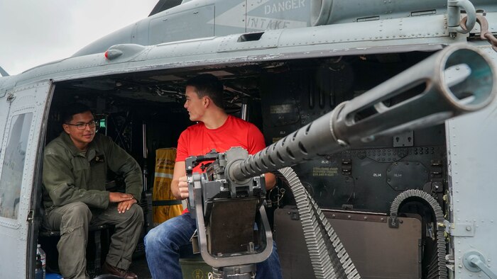 U.S. Marine Corps Sgt. George Navarro, left, teaches a poolee about the UH-1Y Venom helicopter during a tour of the amphibious transport dock USS Somerset (LPD 25) during San Francisco Fleet Week 2024 in San Francisco, Oct. 12, 2024. SFFW, now in its 43rd iteration, is a time-honored sea service celebration that allows citizens of the Bay Area to witness today’s maritime capabilities firsthand. Nearly 2,500 Sailors, Marines, and Coast Guardsmen will showcase their capabilities and equipment, participate in various community service events, and enjoy the hospitality of the Bay Area during the event. (U.S. Marine Corps photo by Lance Cpl. Avery Wayland)
