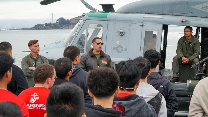 U.S. Marine Corps Capt. Robert Shaw, center, a pilot with Marine Light Attack Helicopter Squadron 169, discusses the UH-1Y Venom helicopter during a tour of the amphibious transport dock USS Somerset(LPD 25) during San Francisco Fleet Week 2024 in San Francisco, Oct. 12, 2024. SFFW, now in its 43rd iteration, is a time-honored sea service celebration that allows citizens of the Bay Area to witness today’s maritime capabilities firsthand. Nearly 2,500 Sailors, Marines, and Coast Guardsmen will showcase their capabilities and equipment, participate in various community service events, and enjoy the hospitality of the Bay Area during the event. (U.S. Marine Corps photo by Lance Cpl. Avery Wayland)