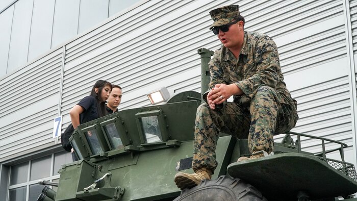 U.S. Marine Corps Cpl. Giovanni AguilarAppell, a light armored reconnaissance Marine with 3rd Light Armored Reconnaissance Battalion, 1st Marine Division, gives insight on Light Armored Vehicles during a tour of the amphibious transport dock USS Somerset (LPD 25) during San Francisco Fleet Week 2024 in San Francisco, Oct. 12, 2024. SFFW, now in its 43rd iteration, is a time-honored sea service celebration that allows citizens of the Bay Area to witness today’s maritime capabilities firsthand. Nearly 2,500 Sailors, Marines, and Coast Guardsmen will showcase their capabilities and equipment, participate in various community service events, and enjoy the hospitality of the Bay Area during the event. (U.S. Marine Corps photo by Lance Cpl. Avery Wayland)