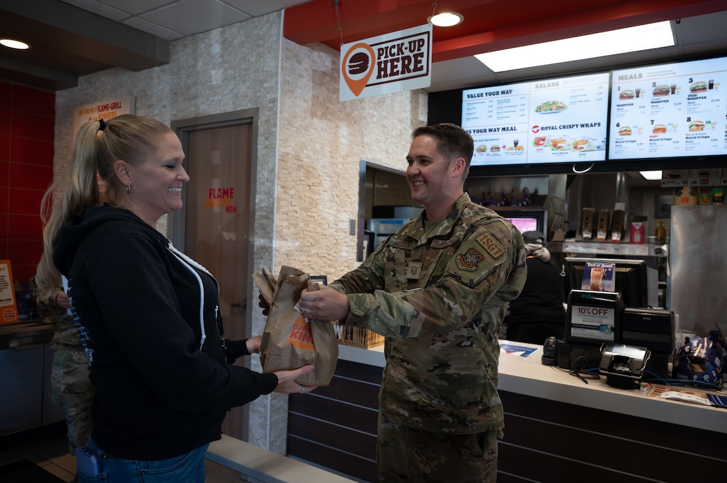 U.S. Air Force Master Sgt. Collin Malcolm, 736th Aircraft Maintenance Squadron first sergeant, hands a Team Dover member their meal during Operation Warm Heart at Dover Air Force Base, Delaware, Oct. 16, 2024. The event was facilitated by Team Dover’s first sergeants, Operation Warm Heart is a nonprofit organization that is dedicated to providing emergency financial relief, morale building and quality of life enhancements to military members and their families stationed at Dover AFB. (U.S. Air Force Photo by Senior Airman Dieondiere Jefferies)