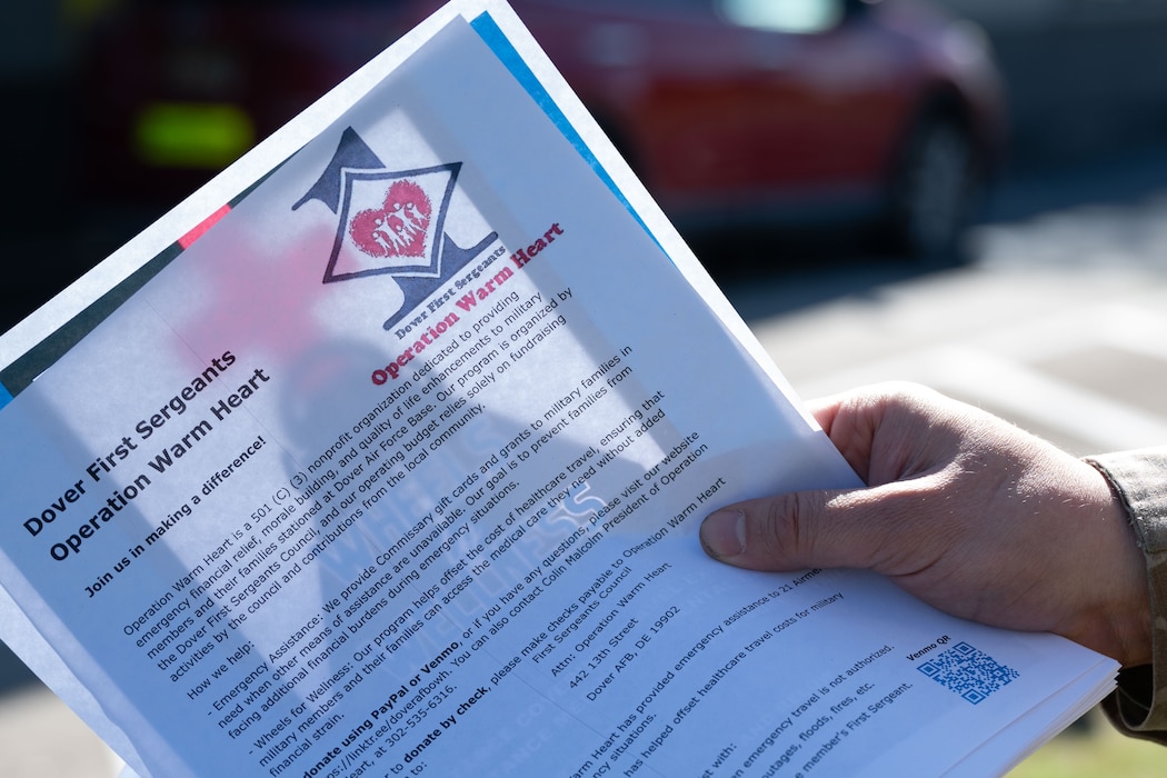 Master Sgt. Collin Malcolm, 736th Aircraft Maintenance Squadron first sergeant, holds a paper with information on Operation Warm Heart at Dover Air Force Base, Delaware, Oct. 16, 2024. The event was facilitated by Team Dover’s first sergeants, Operation Warm Heart is a nonprofit organization that is dedicated to providing emergency financial relief, morale building and quality of life enhancements to military members and their families stationed at Dover AFB. (U.S. Air Force Photo by Senior Airman Dieondiere Jefferies)