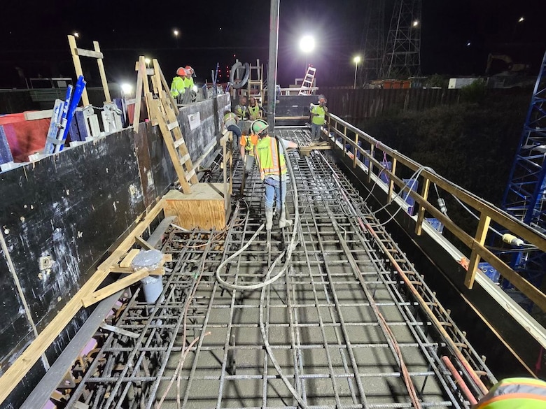 Construction workers from contractor Thalle Construction complete the first monolith “top-out” on the Kentucky Lock Addition Project located in Grand Rivers, KY, Oct. 12, 2024. A monolith is a single structure of concrete that is in the shape of a column. There are a total of 50 monoliths that are to be constructed made from five-foot layers of concrete. Each five-foot layer is called a lift. Early Saturday morning, the final concrete lift was completed for a monolith located on the downstream side of the lock being constructed.