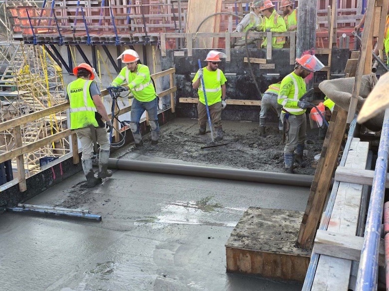 Construction workers from contractor Thalle Construction complete the first monolith “top-out” on the Kentucky Lock Addition Project located in Grand Rivers, KY, Oct. 12, 2024. A monolith is a single structure of concrete that is in the shape of a column. There are a total of 50 monoliths that are to be constructed made from five-foot layers of concrete. Each five-foot layer is called a lift. Early Saturday morning, the final concrete lift was completed for a monolith located on the downstream side of the lock being constructed.