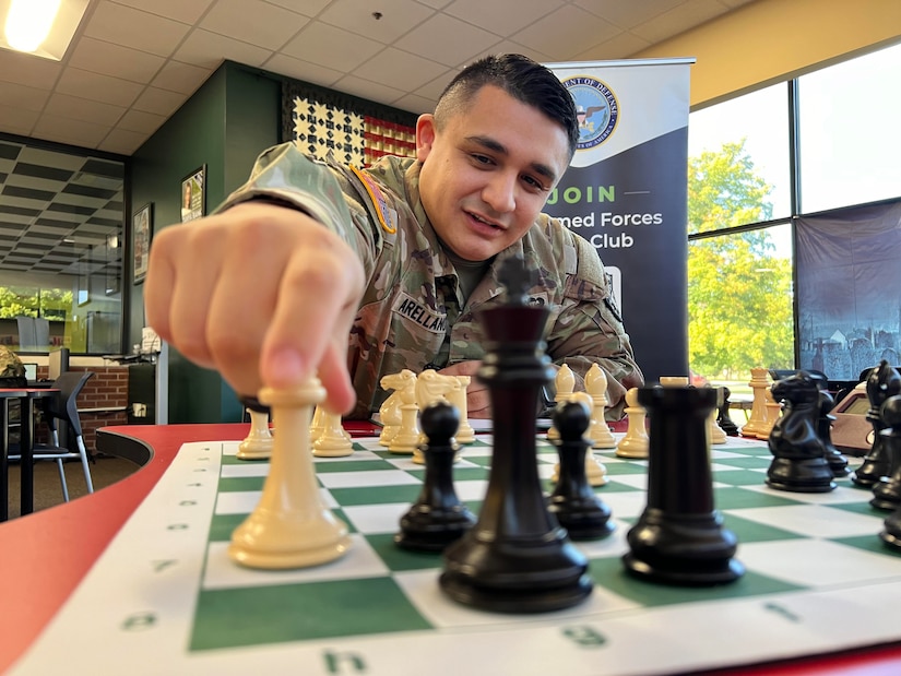 U.S. Army Soldier in uniform executes chess move