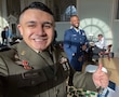 U.S. Army Soldier in dress uniform poses with a member of another Armed Forces Branch in dress uniform